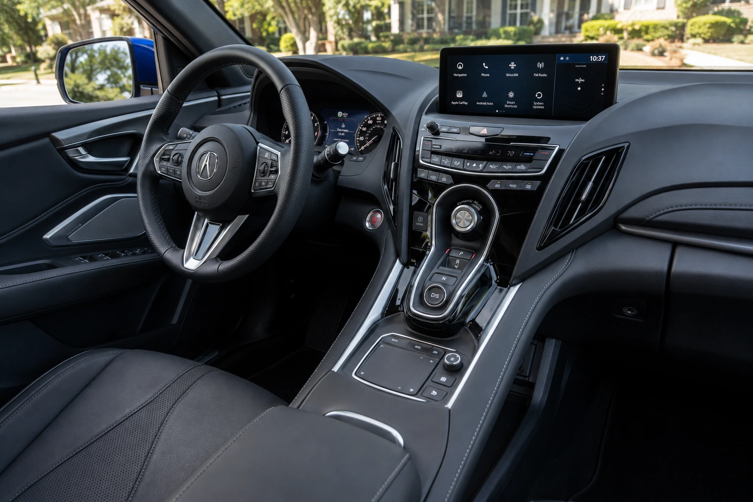 The Acura RDX's driver-focused cockpit and touchpad infotainment controller shown in natural daylight.
