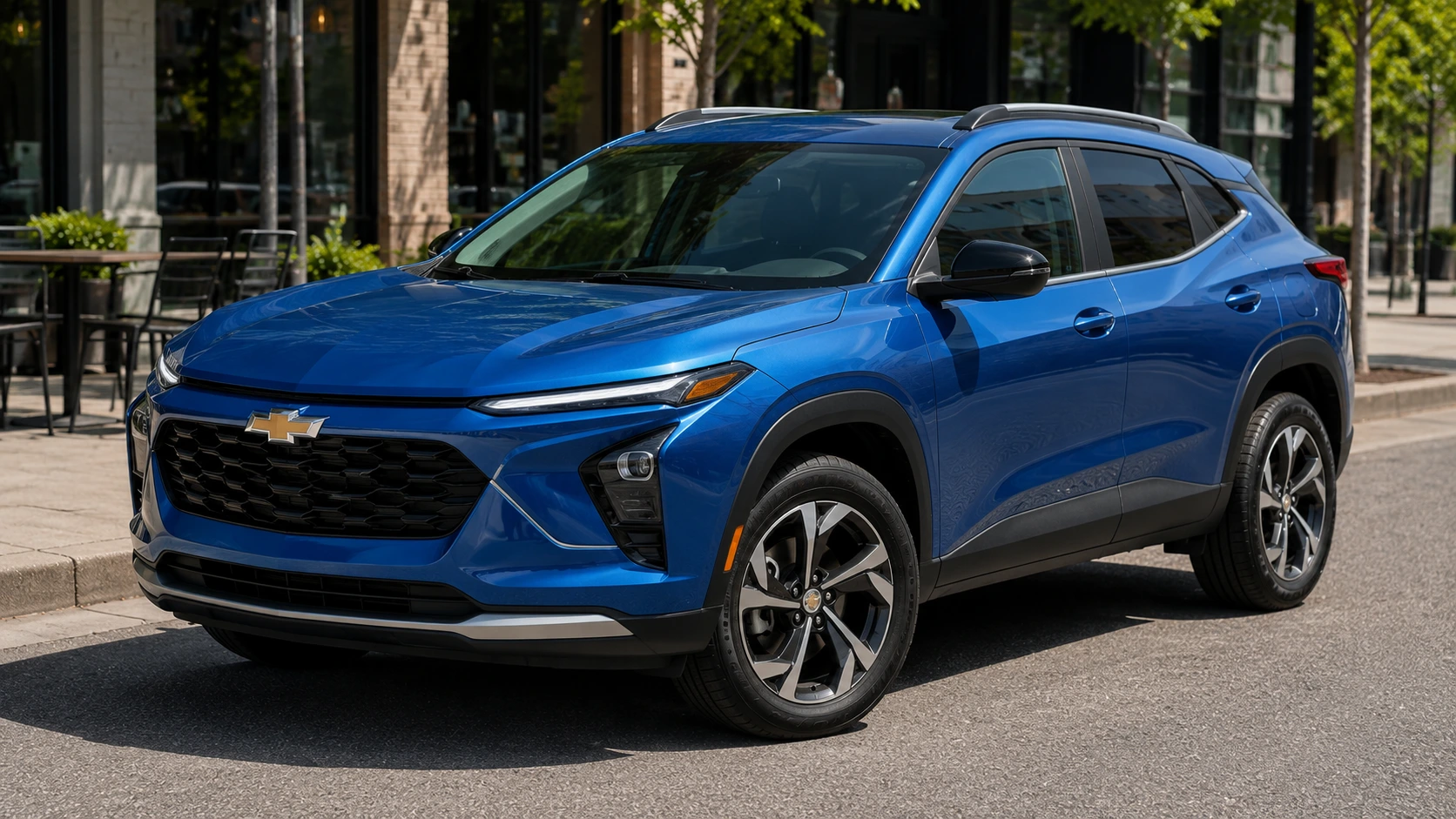 A blue 2026 Chevrolet Trax subcompact SUV parked on a city street in daylight, shot candidly at a three-quarter angle.