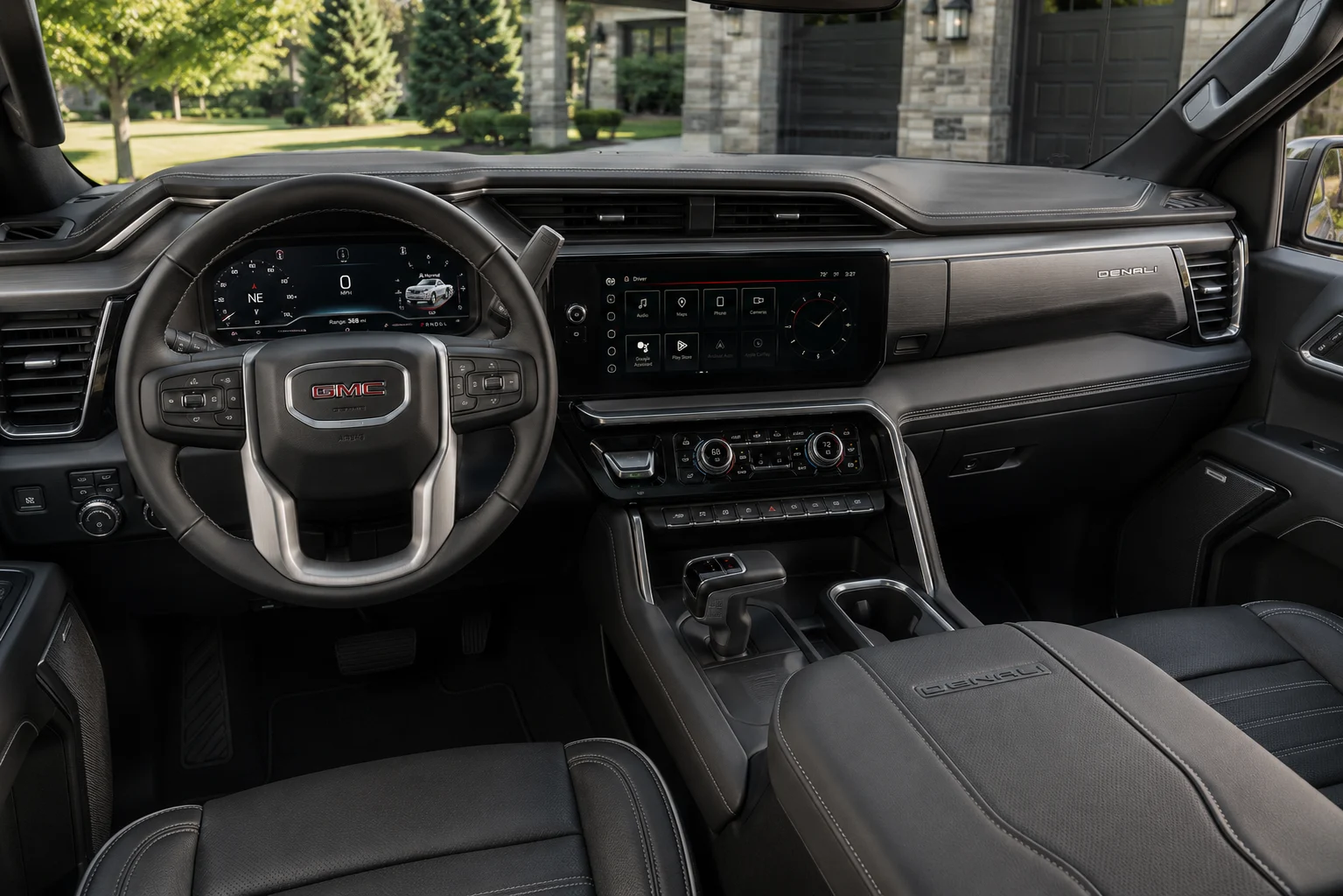 The upscale dashboard and touchscreen of a GMC Sierra 1500 Denali, lit by natural daylight.
