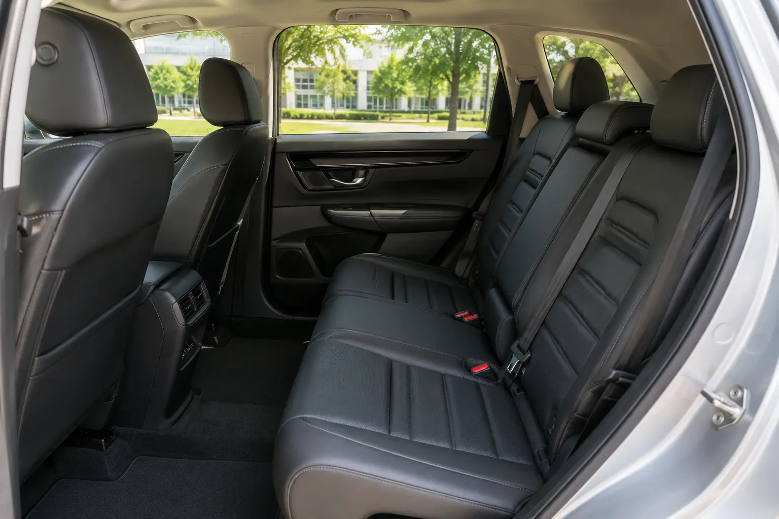 The Honda CR-V's spacious rear seat area shown in natural light through the side windows.