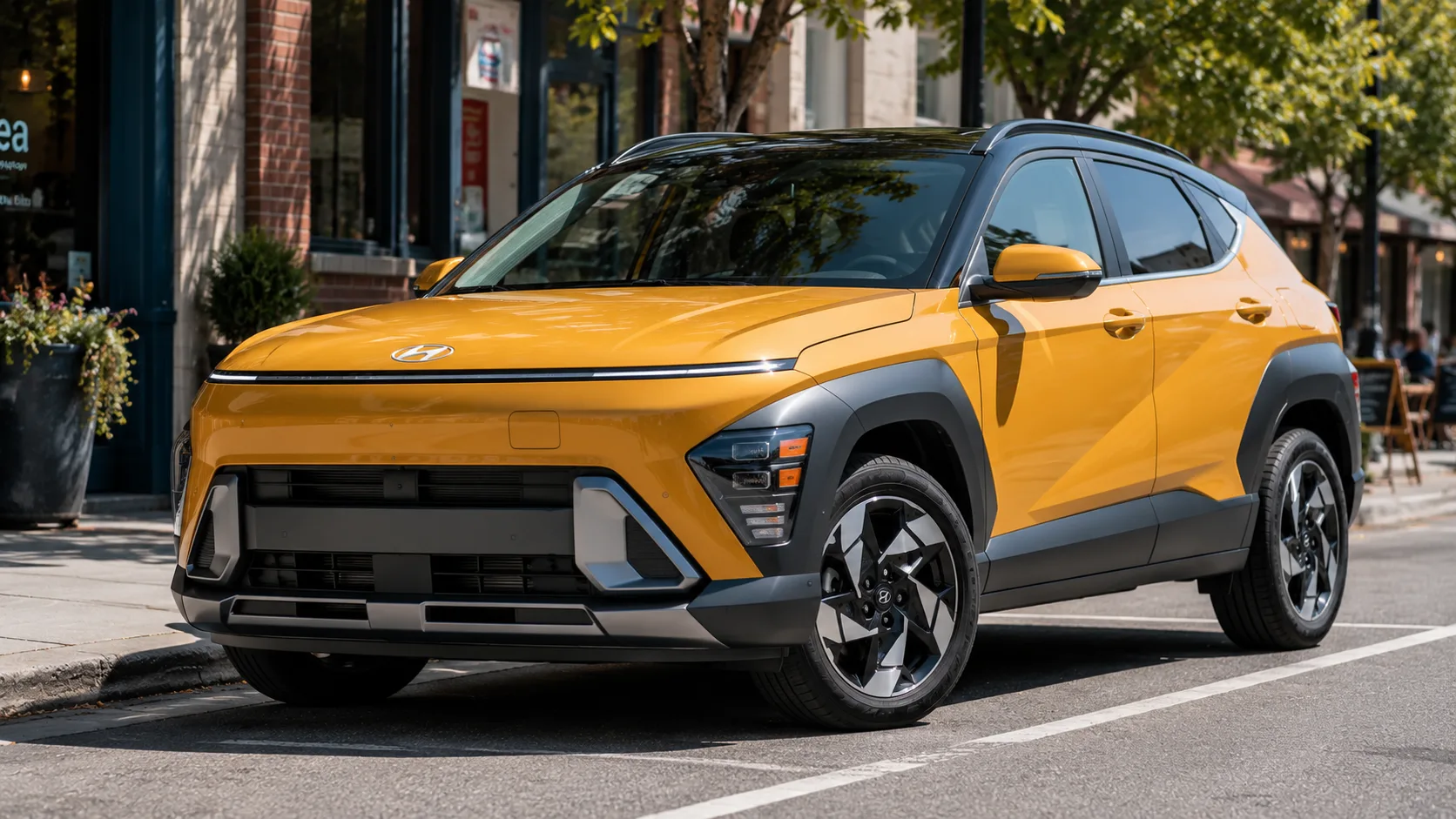 A yellow-orange 2026 Hyundai Kona crossover parked on a city street in daylight, shot candidly at a three-quarter angle.