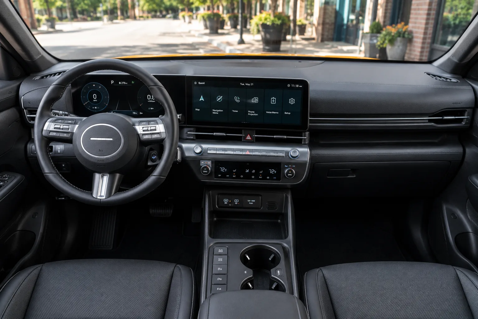 The dashboard and infotainment display of a Hyundai Kona, lit by natural daylight.