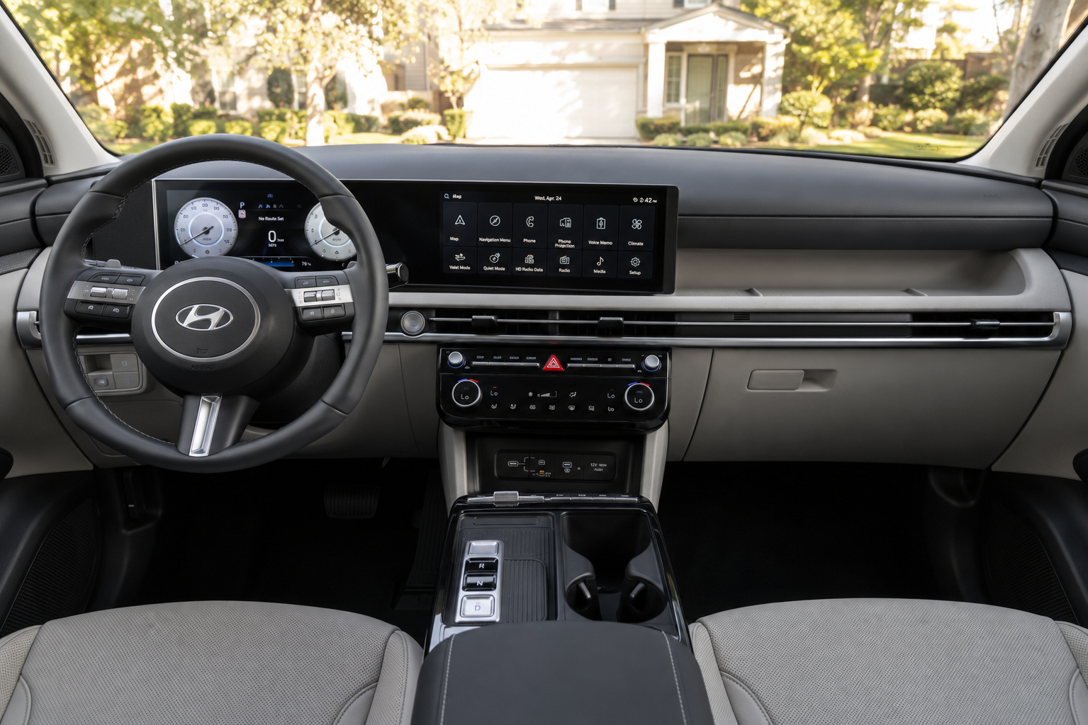 The dashboard and large touchscreen display of a Hyundai Tucson, lit by natural daylight.