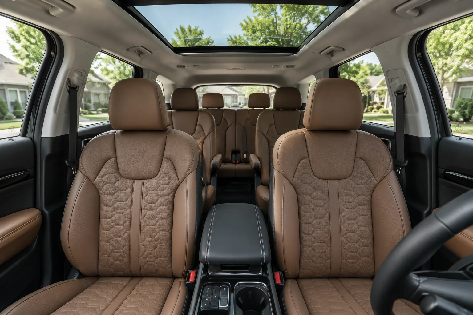 The three-row interior of a Kia Sorento, lit by natural daylight through the panoramic sunroof.