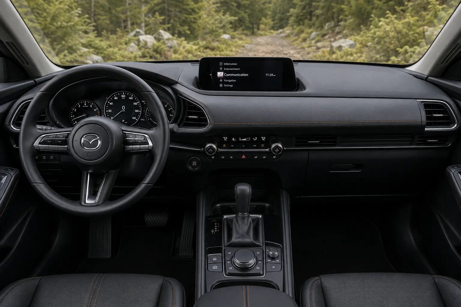The dashboard and infotainment display of a Mazda CX-50, lit by natural daylight.