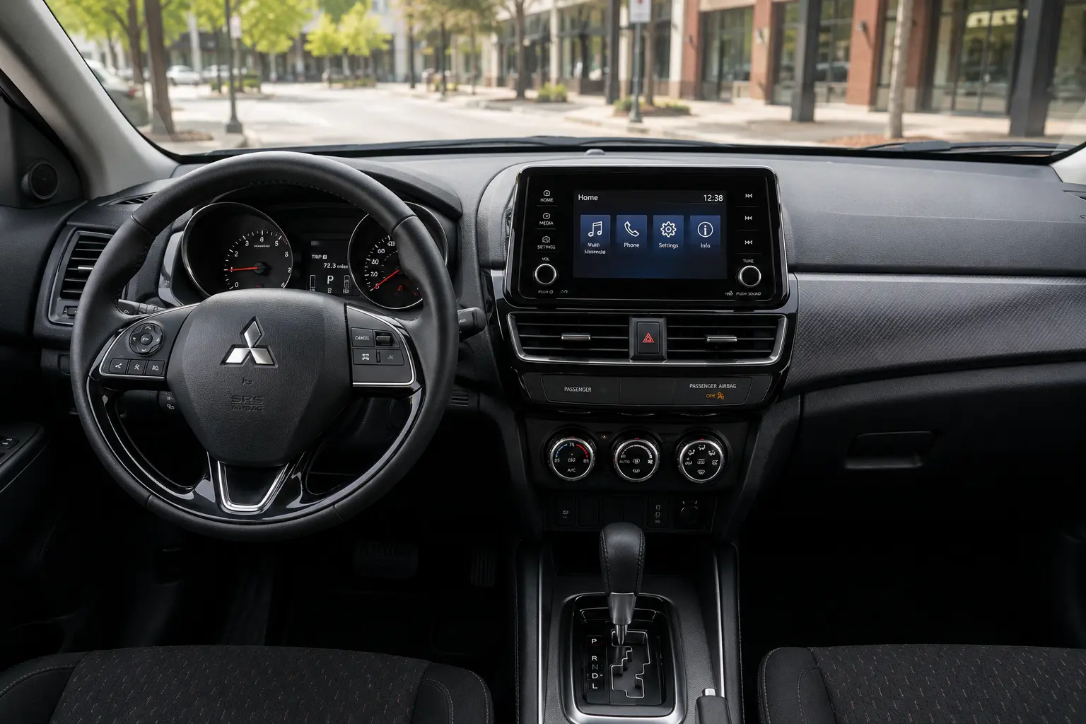 The dashboard and 8-inch touchscreen of a Mitsubishi Outlander Sport, lit by natural daylight.