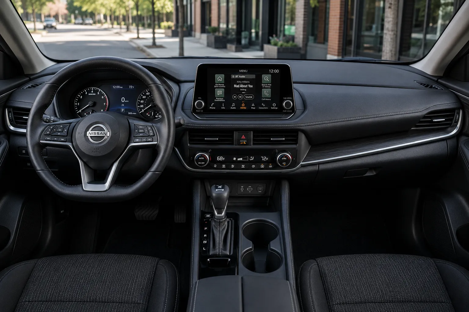 The dashboard and touchscreen of a Nissan Altima, lit by natural daylight.