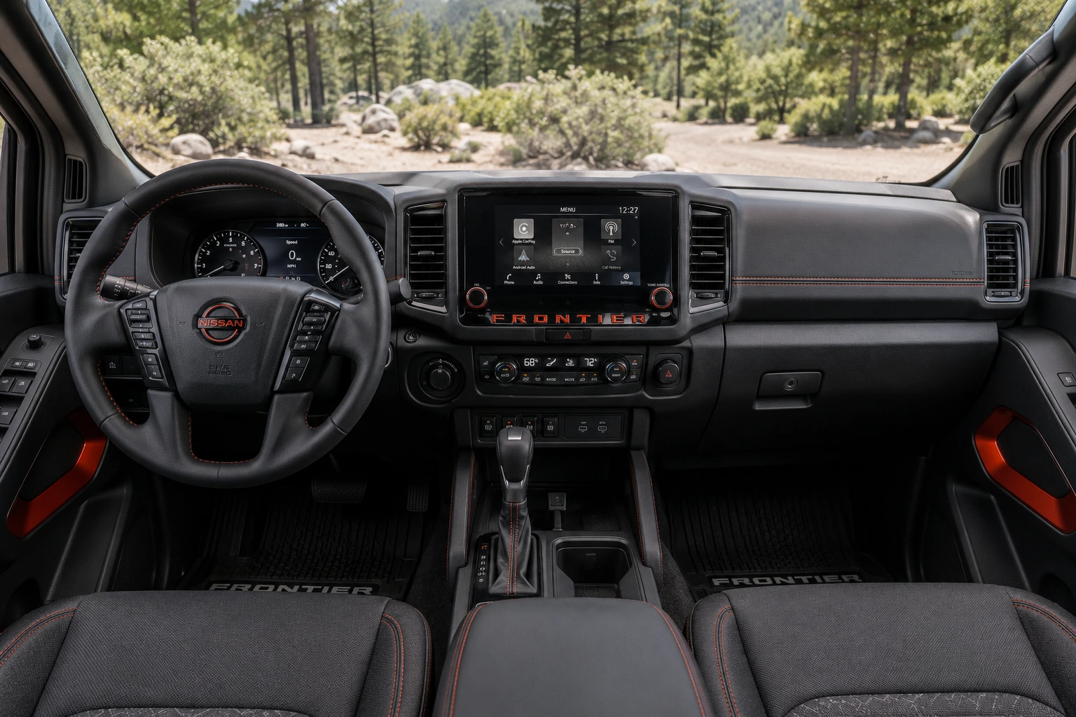 The crew-cab interior of a Nissan Frontier, dashboard and touchscreen, natural daylight.