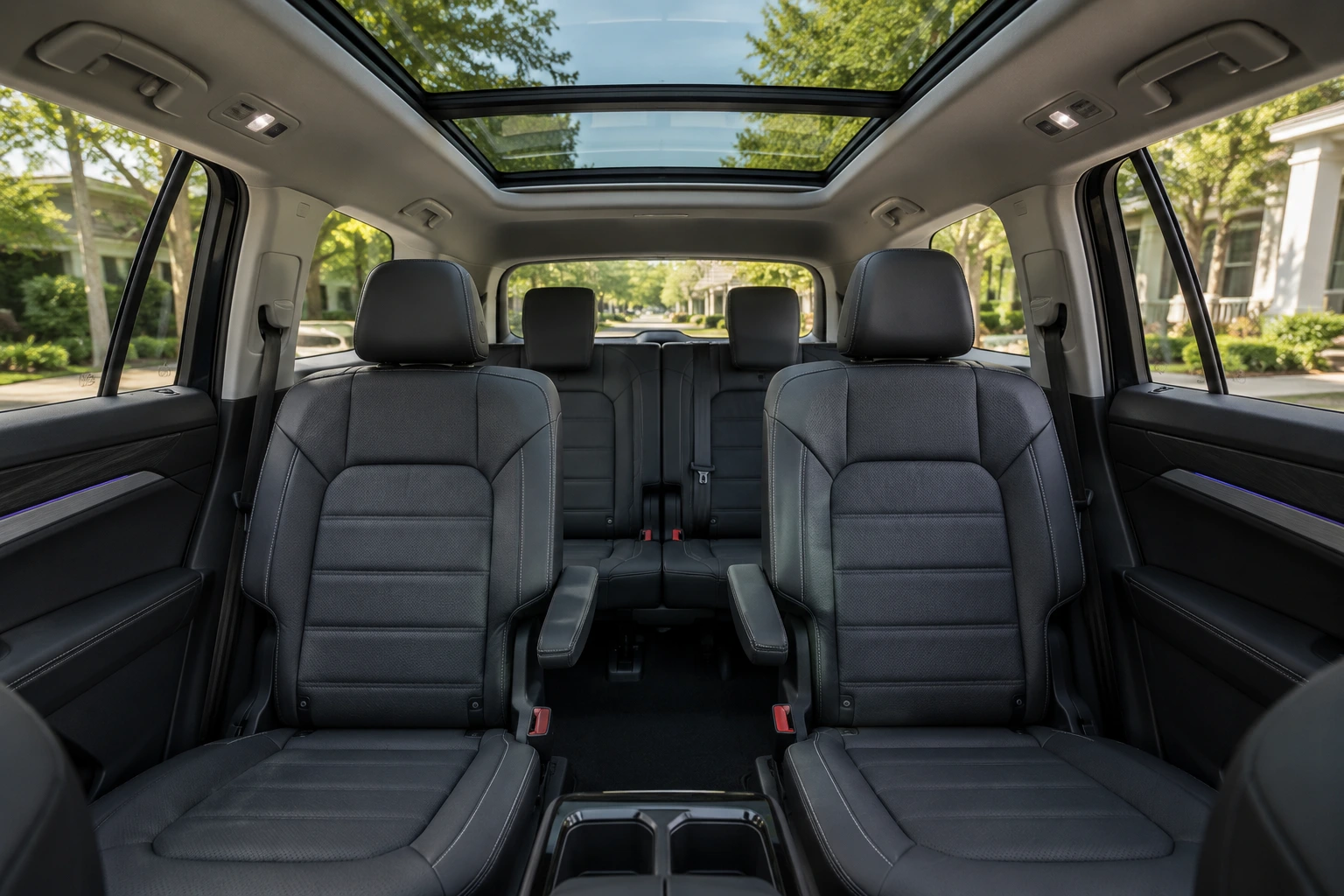 The three-row interior of a Volkswagen Atlas, lit by natural daylight through the panoramic sunroof.