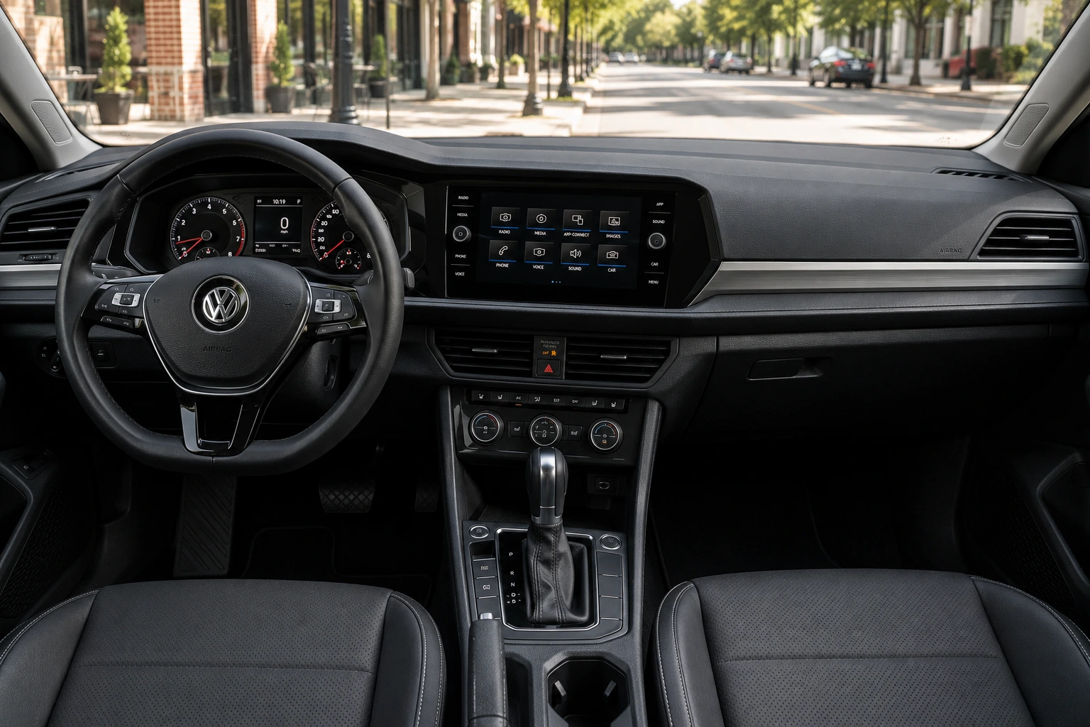 The dashboard and touchscreen of a Volkswagen Jetta, lit by natural daylight.