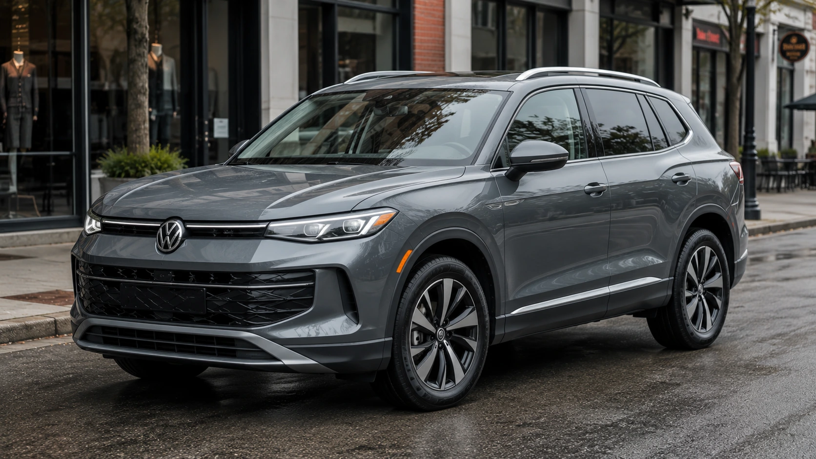 A gray 2026 Volkswagen Tiguan crossover parked on a city street in overcast daylight, shot candidly at a three-quarter angle.